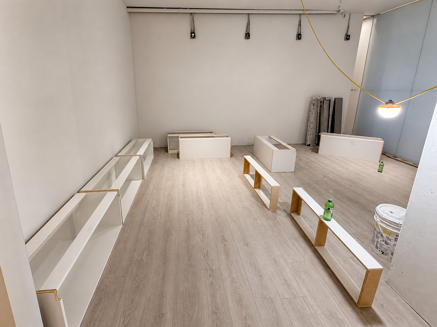 Shifeon commercial millwork and display units arranged across new flooring during installation.